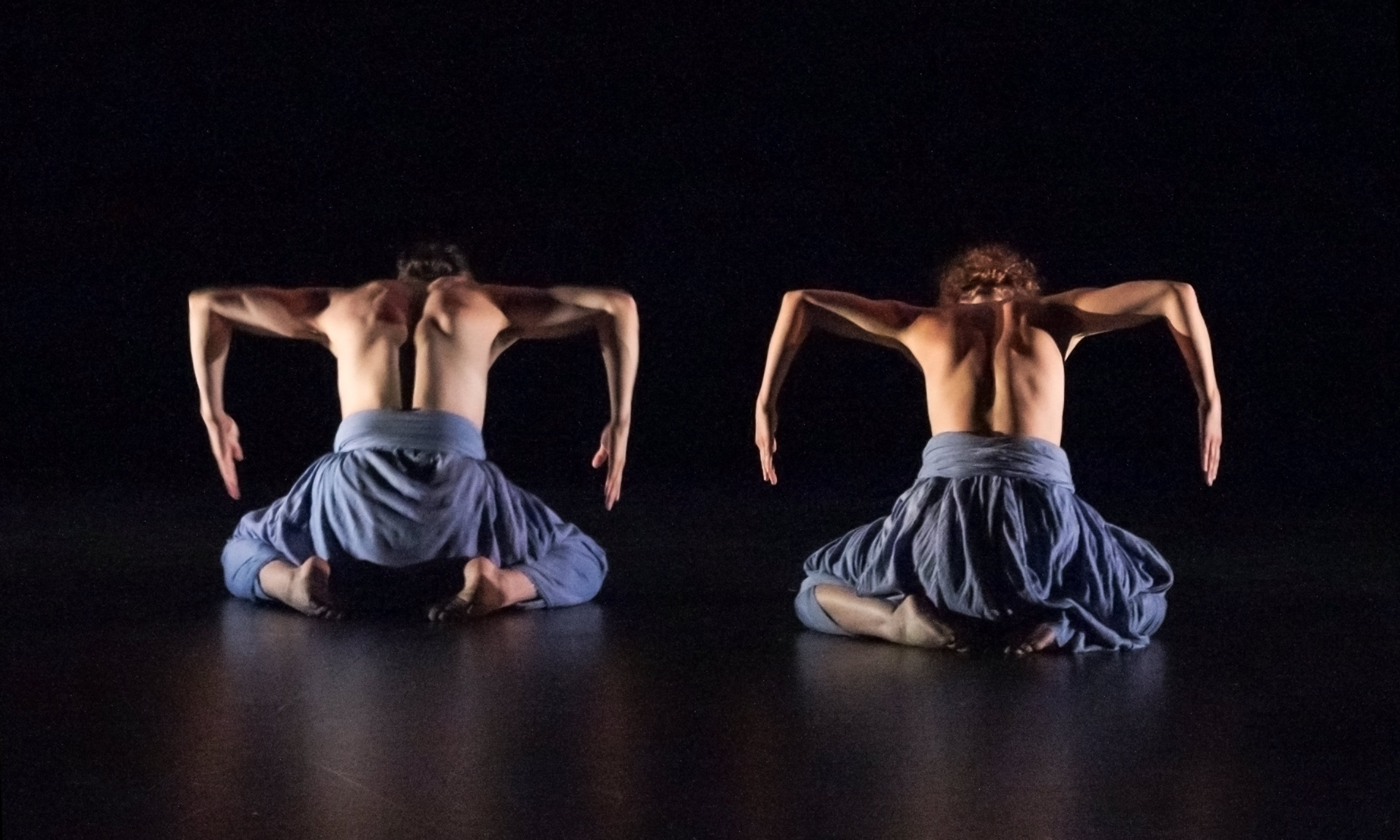 push/FOLD dancers Jessica Evans and Samuel Hobbs perform 'Whisper' at Conduit's Dance+ at Reed College in Portland, Oregon. Kneeling in blue pants with their arms in a bracket position, hands pointings down | Photography: Jim Lykins