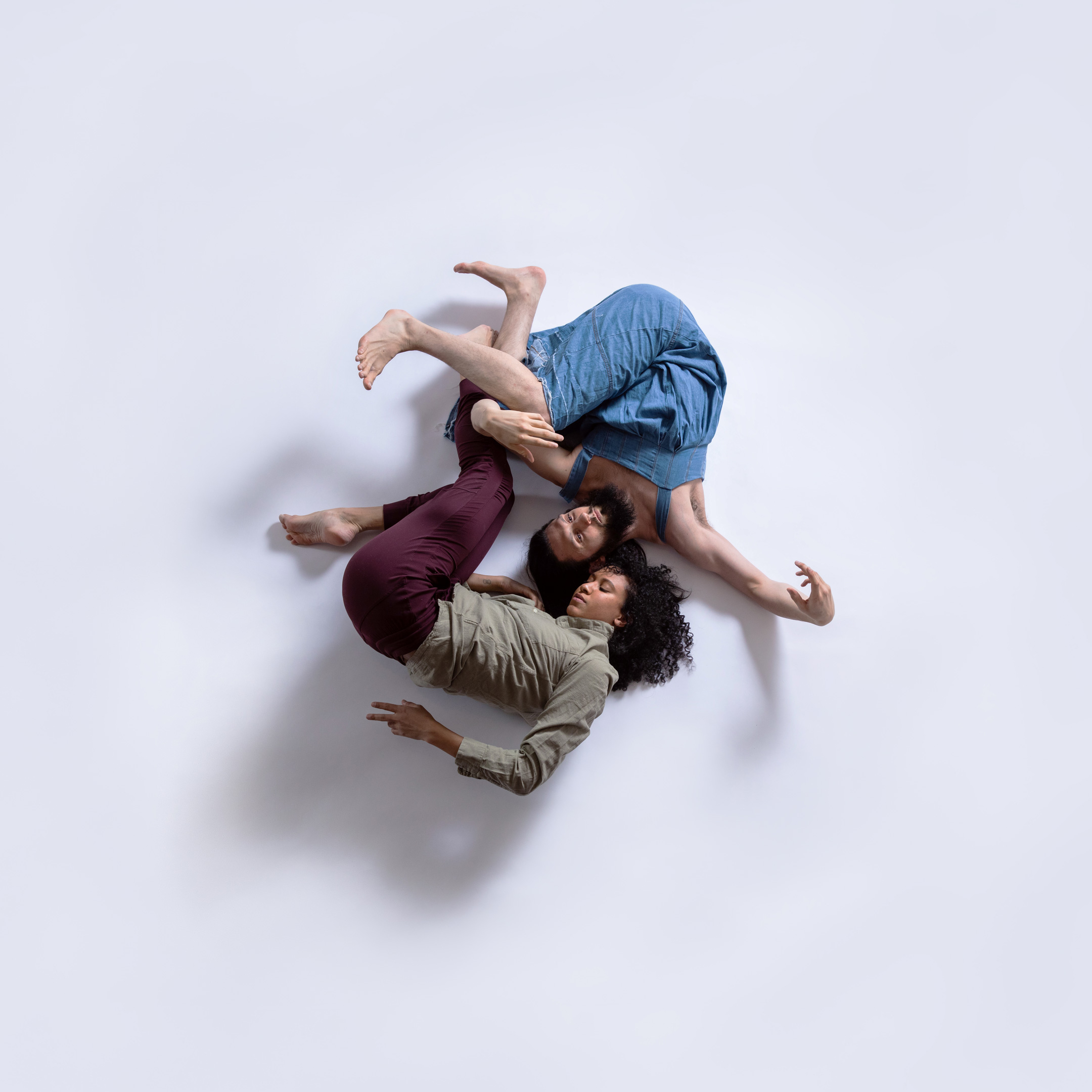 push/FOLD dancers Smauel Hobbs and Ashley Morton pose in an intimate circle wearing linen shirts and a jean dress at Tempos Circus Studio in Portland, Oregon | Photography: Gregory Bartning