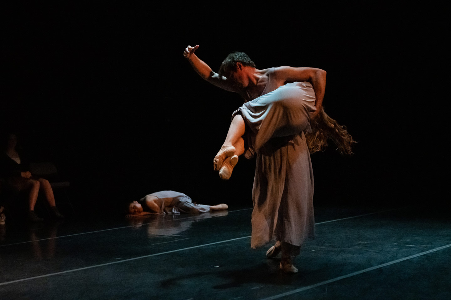 Dancers perform Union PDX - Festival:22 artist Makino Hayashi's work 'What do you see'. Photo depicts male dancer carrying a femail dancer sideways | Photography: Jingzi Zhao