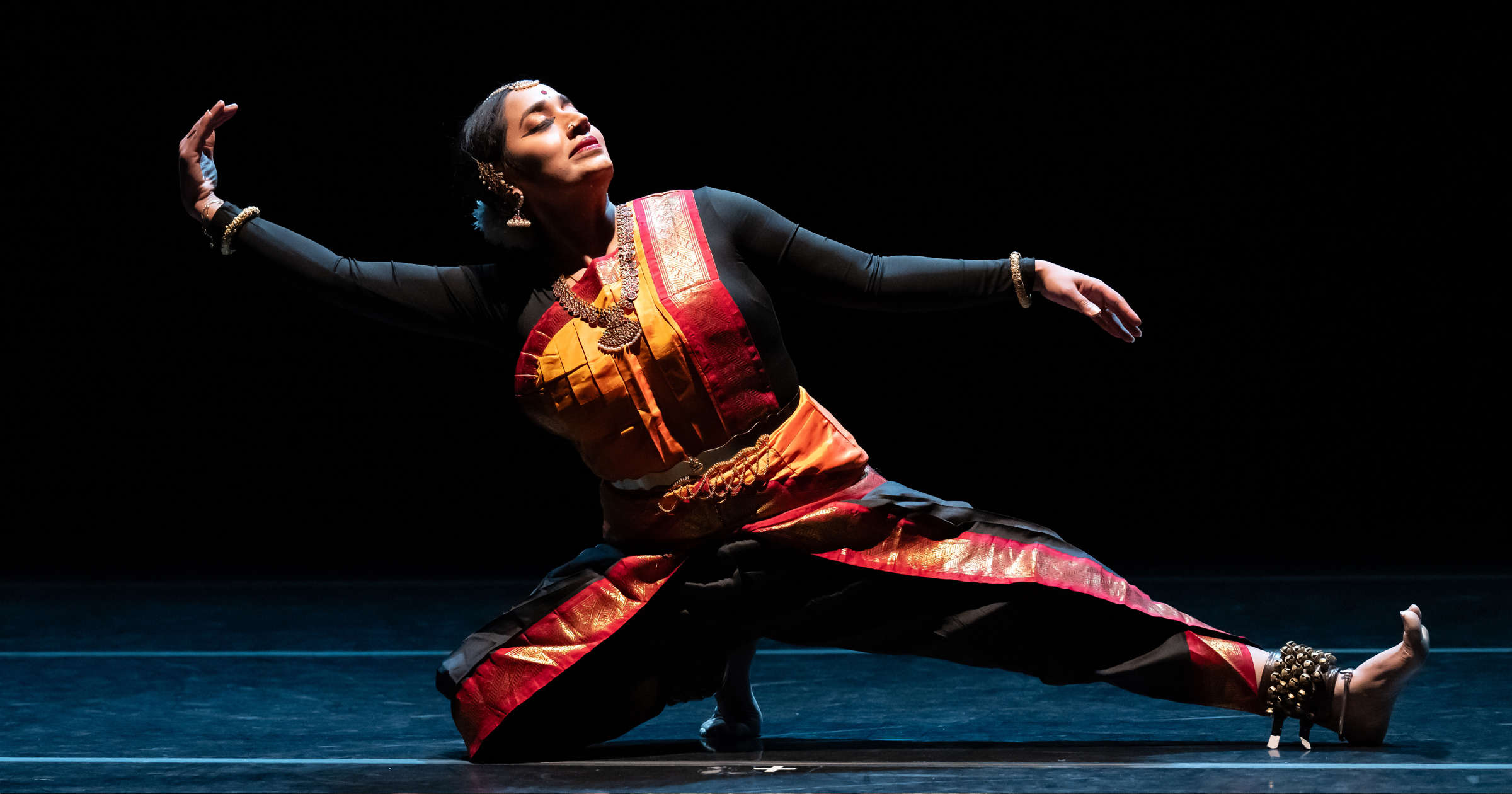 Union PDX - Festival:23 artist Sridharini Sridharan performing her solo 'Clarion Call' at the Hampton Opera Center in Portland, Oregon. The number 26 overlays the image to indicate the festival year. | Photography: Jingzi Zhao